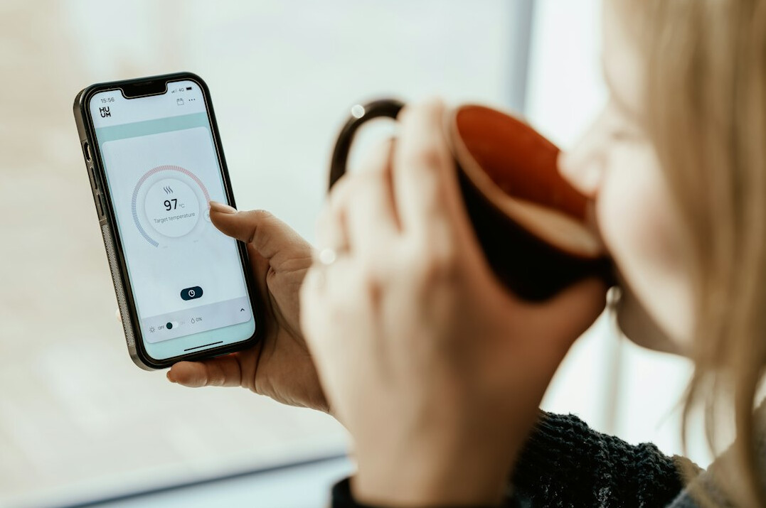 person using smart thermostat